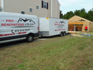 A Truck and a Storage Container With Pro Renovations Logo